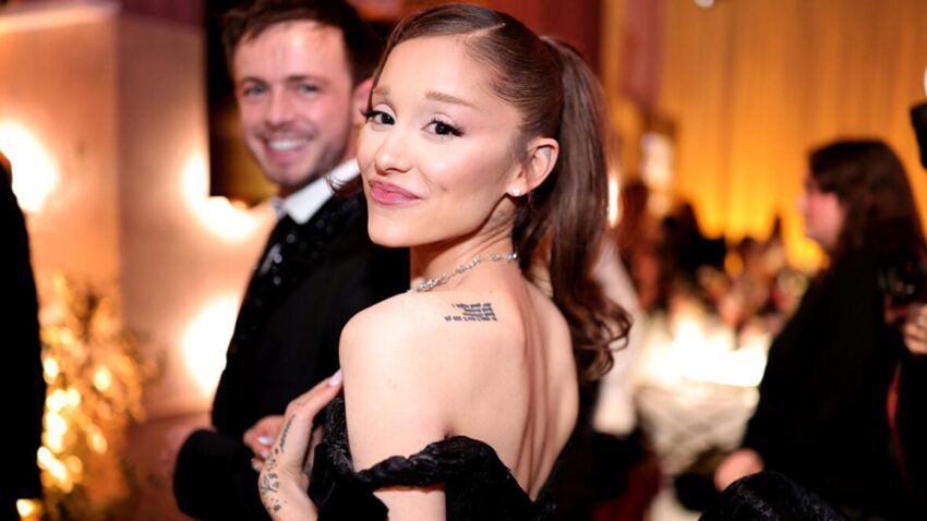 Ariana Grande looks over her shoulder in a black off-the-shoulder gown at the Golden Globes.